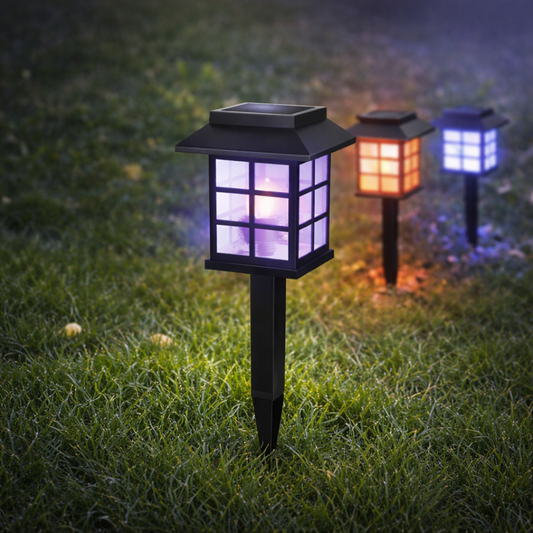 Solar garden lights with colorful glass covers on grass